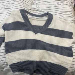 this is an oversized sweater from american eagle. it has grey and white stripes.